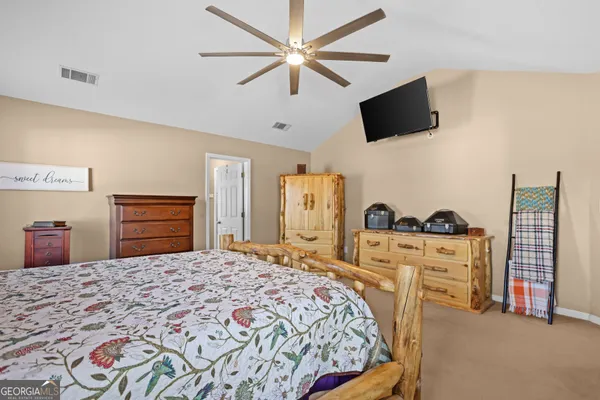 a bed sitting in a bedroom next to a window