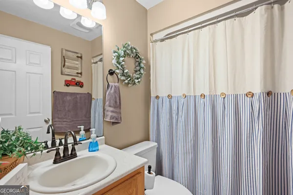 a bathroom with a sink vanity granite and a mirror