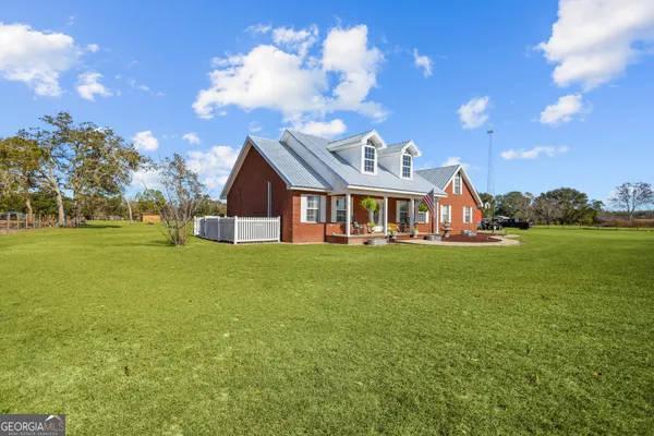 a front view of house with yard and green space