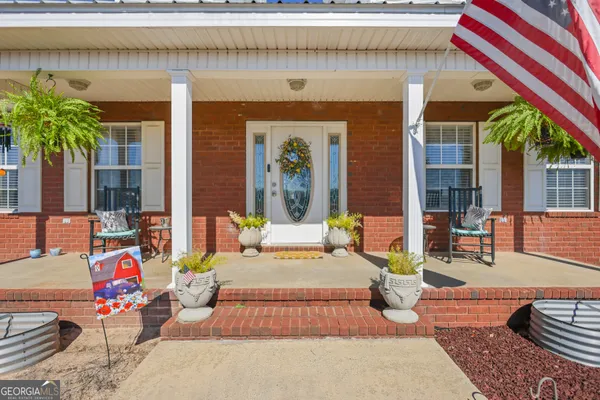 a front view of a house with outdoor seating