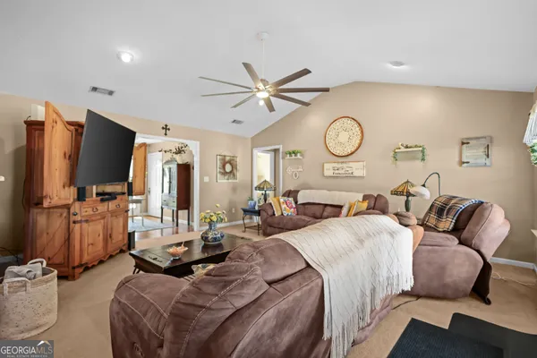 a kitchen with stainless steel appliances granite countertop a refrigerator a stove and a sink