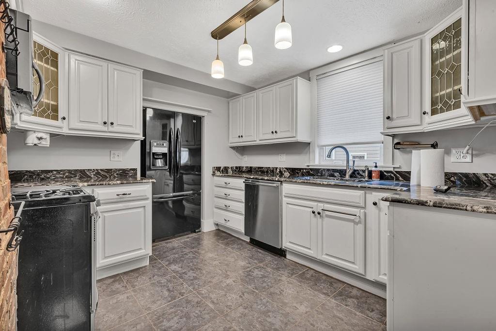 338 Buffalo Street Beaver, PA 15009 - Photo 2 of 21 a kitchen with stainless steel appliances granite countertop a stove sink and cabinets