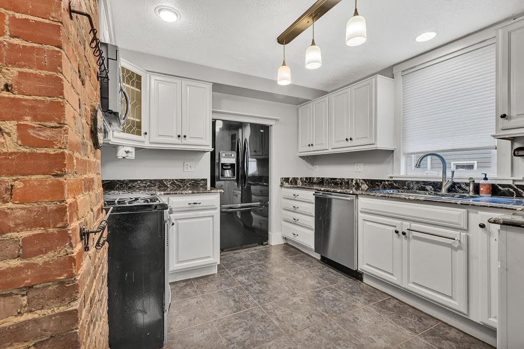 338 Buffalo Street Beaver, PA 15009 - Photo 3 of 21 a kitchen with stainless steel appliances granite countertop a stove a sink and a refrigerator