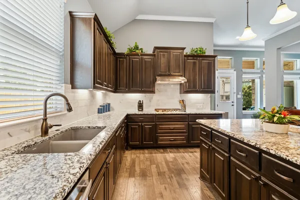 a kitchen with a sink and a stove top oven