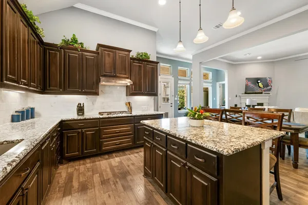 a kitchen with a stove sink and cabinets