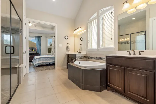 a spacious bathroom with a double vanity sink mirror and double
