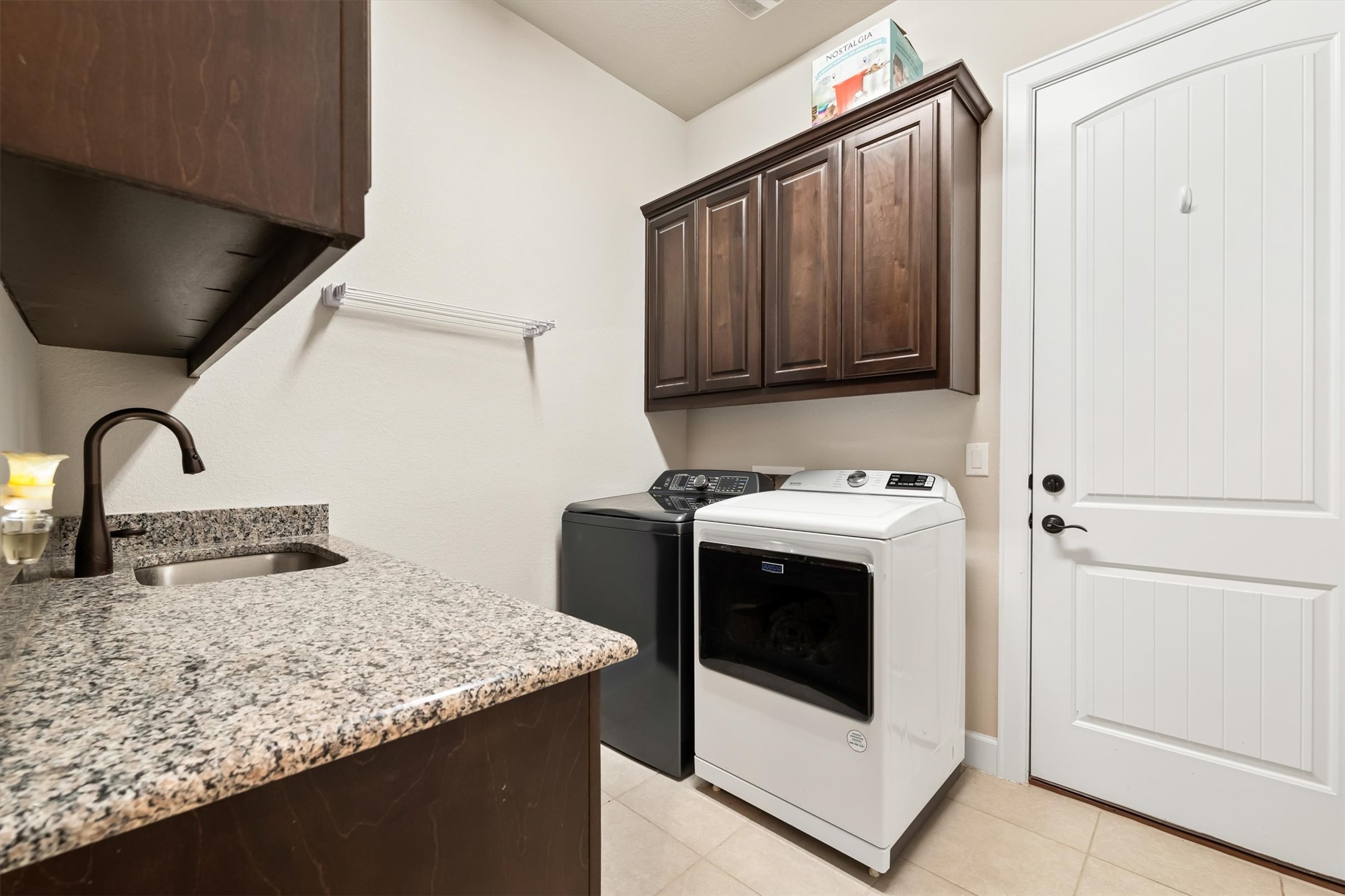 1004 Hezekiah Lane Leander, TX 78641 - Photo 23 of 36 a view of a kitchen with a sink and washing machine