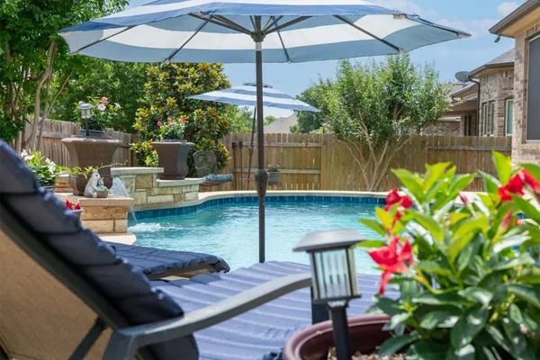 a view of a chairs and table under an umbrella