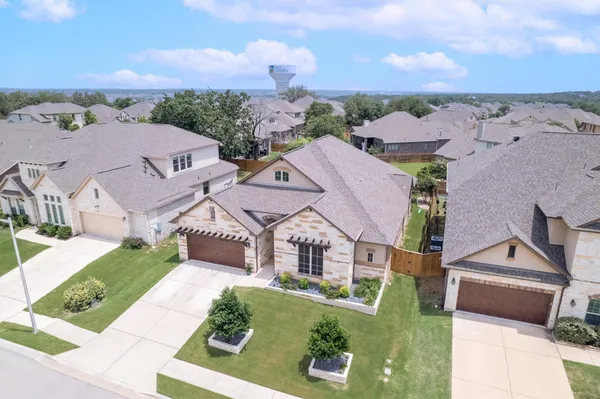 an aerial view of multiple houses with a big yard