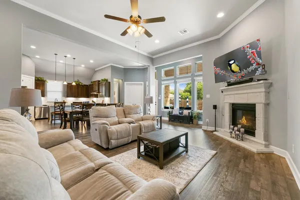 a living room with furniture a fireplace and a flat screen tv