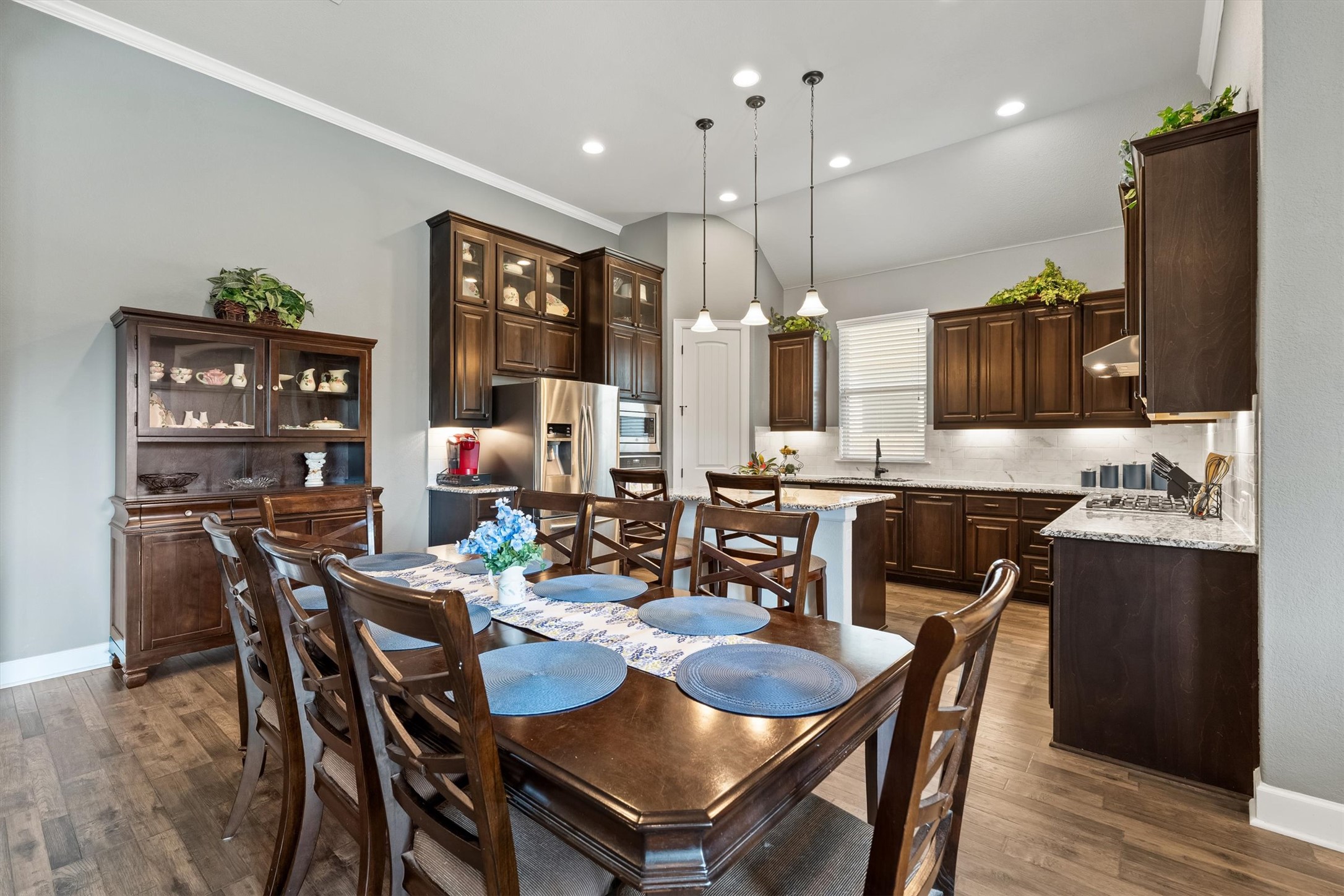 1004 Hezekiah Lane Leander, TX 78641 - Photo 10 of 36 a dining room with stainless steel appliances kitchen island granite countertop a dining table chairs and a oven