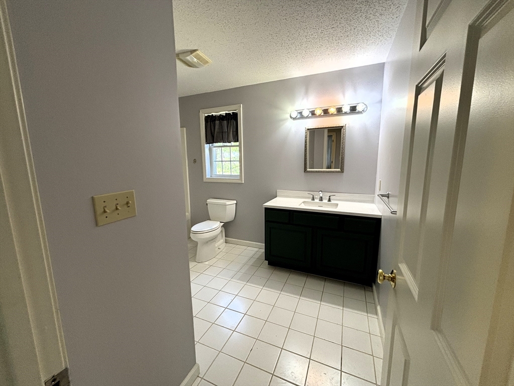 86 Coffey Hill Road Ware, MA 01082 - Photo 28 of 34 a bathroom with a sink a toilet and mirror