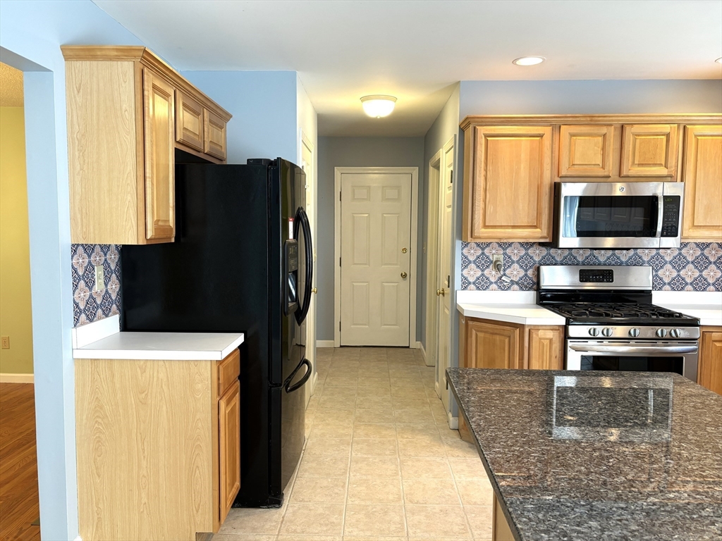 86 Coffey Hill Road Ware, MA 01082 - Photo 8 of 34 a kitchen with a refrigerator a stove and a sink