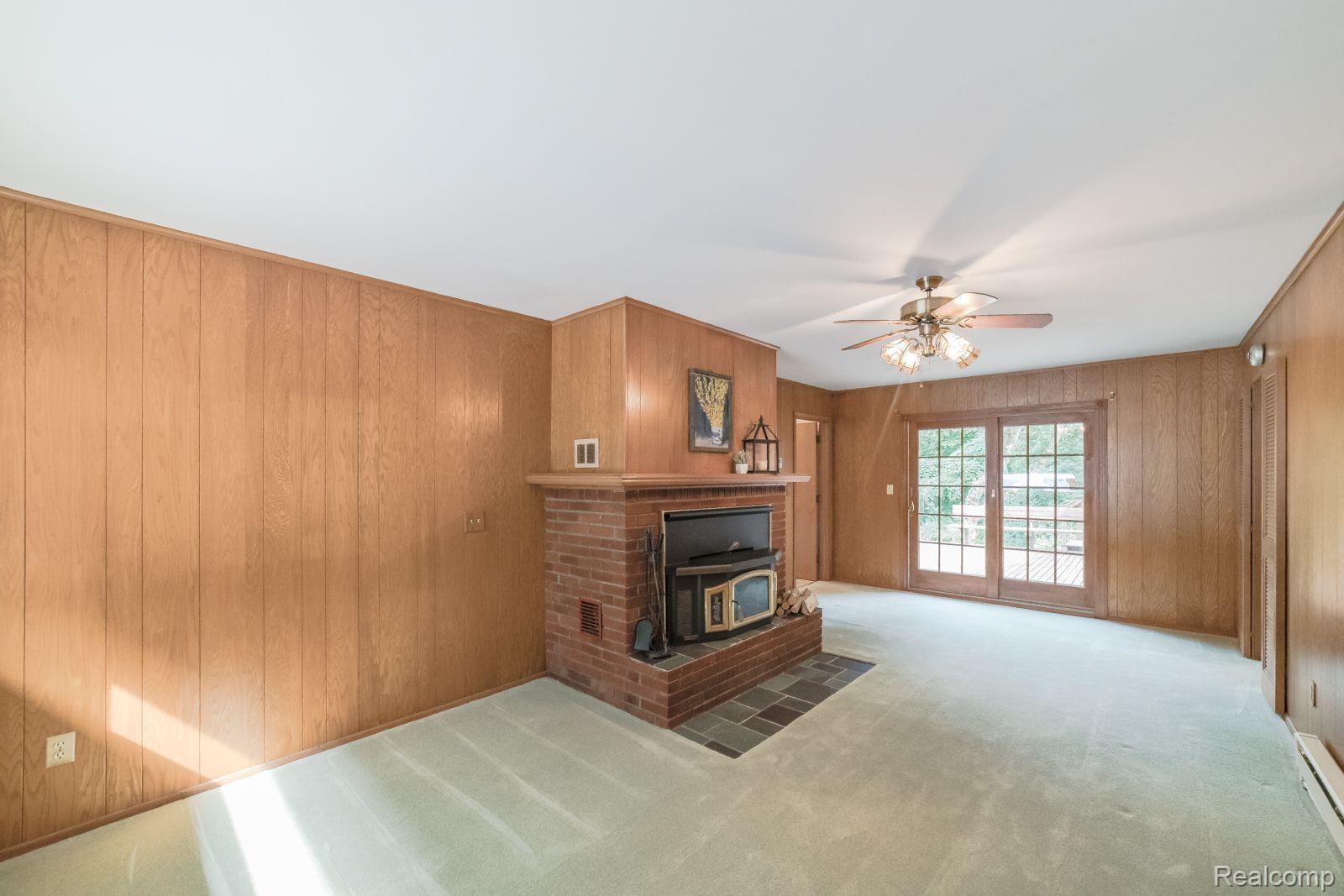 3925 Welch Road Attica, MI 48412 - Photo 19 of 40 Cozy den with fireplace & access to deck