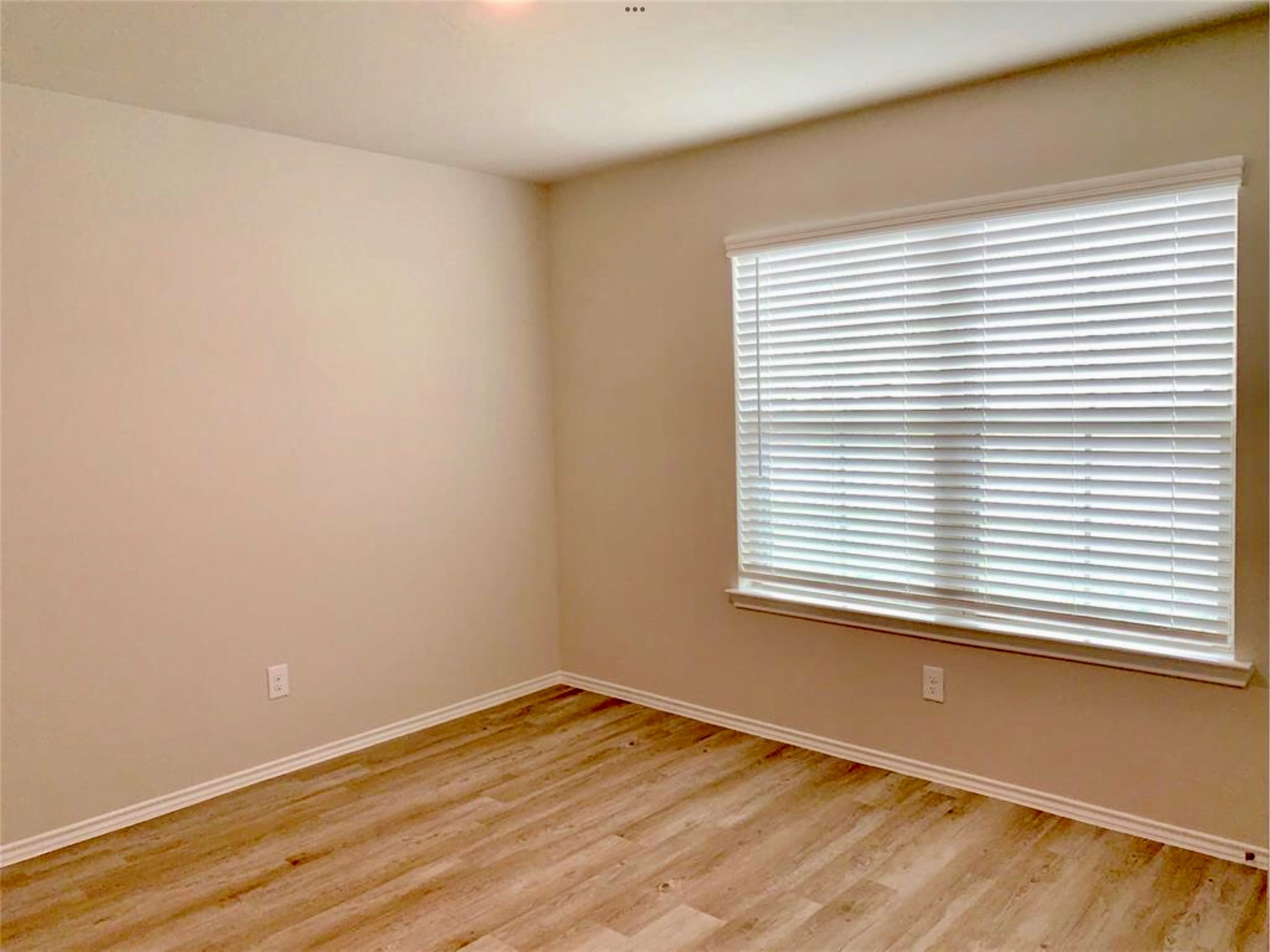 2203 Levant Lane Baytown, TX 77523 - Photo 12 of 17 a view of an empty room with wooden floor and a window