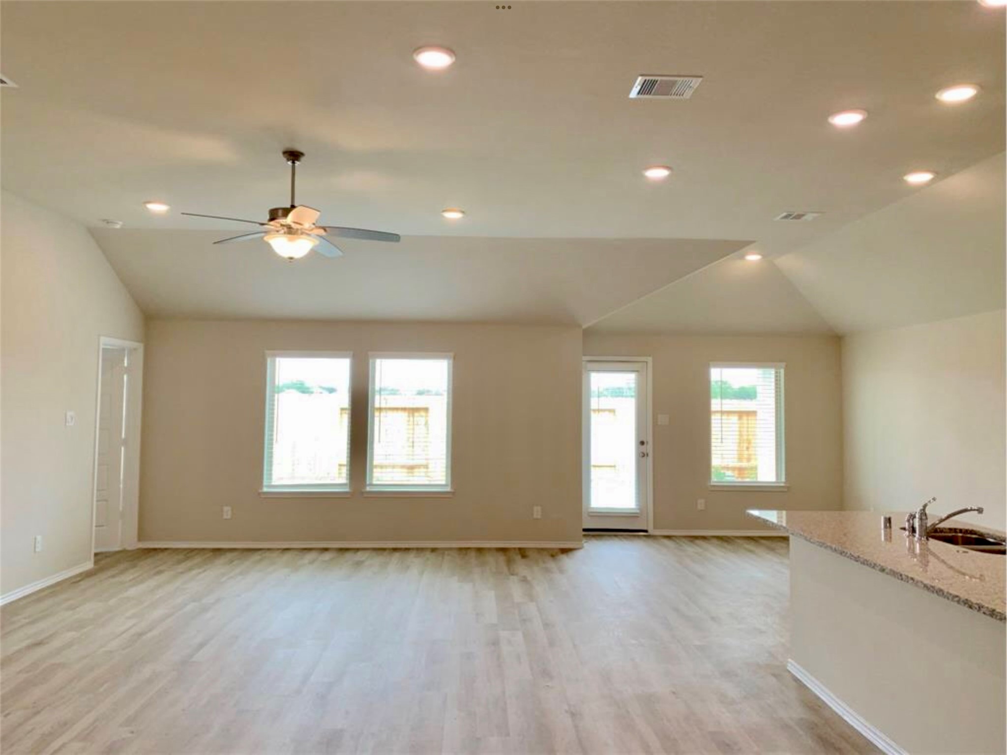 2203 Levant Lane Baytown, TX 77523 - Photo 2 of 17 a view of an empty room with window and wooden floor