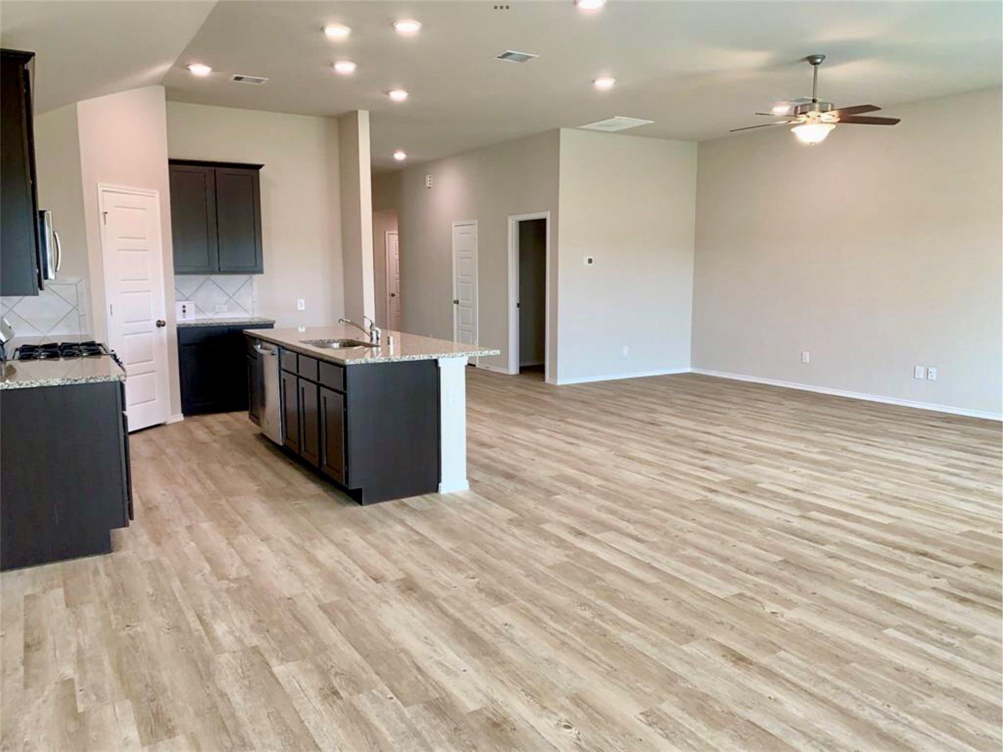 2203 Levant Lane Baytown, TX 77523 - Photo 6 of 17 a kitchen with stainless steel appliances a large counter top a stove and a refrigerator