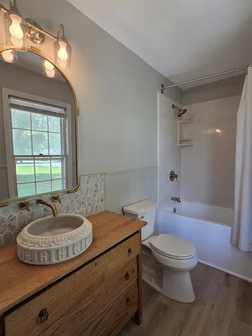 a bathroom with a sink toilet a shower and a mirror