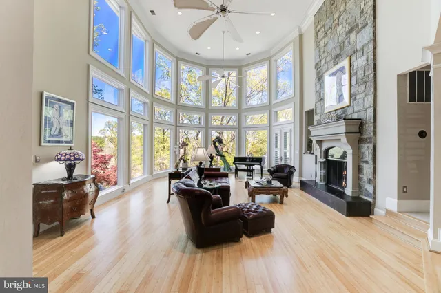 a living room with furniture fireplace and a large window
