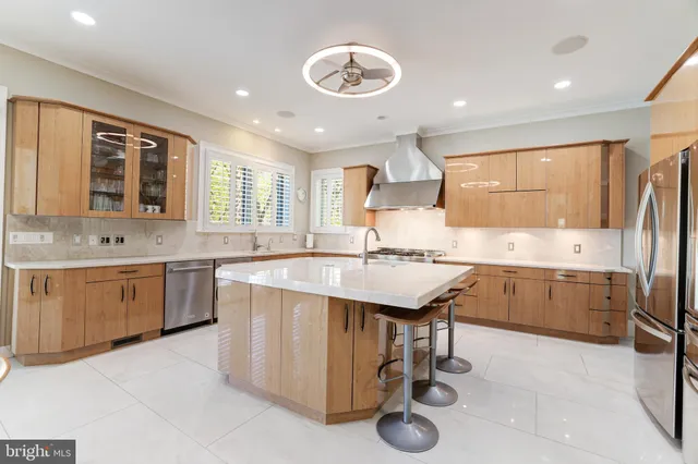 a kitchen with stainless steel appliances granite countertop a sink a stove and a refrigerator