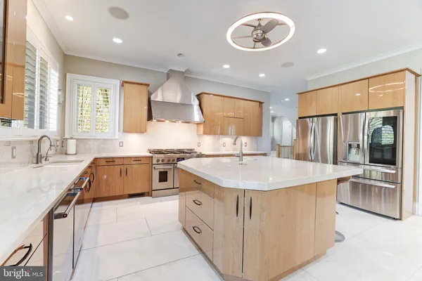a kitchen with granite countertop a sink a washer and dryer