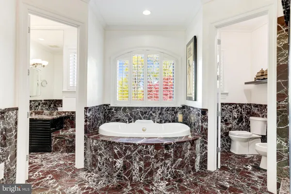 a living room with a large window wooden floor and furniture
