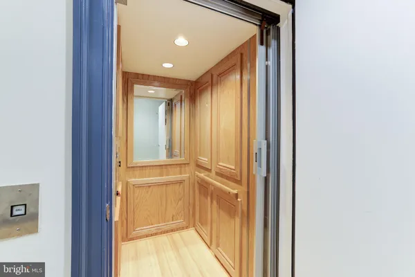 a building outdoor space with patio furniture and potted plants