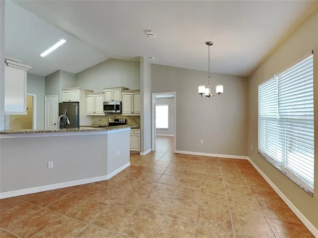 a view of a kitchen with a sink and dishwasher a refrigerator freezer