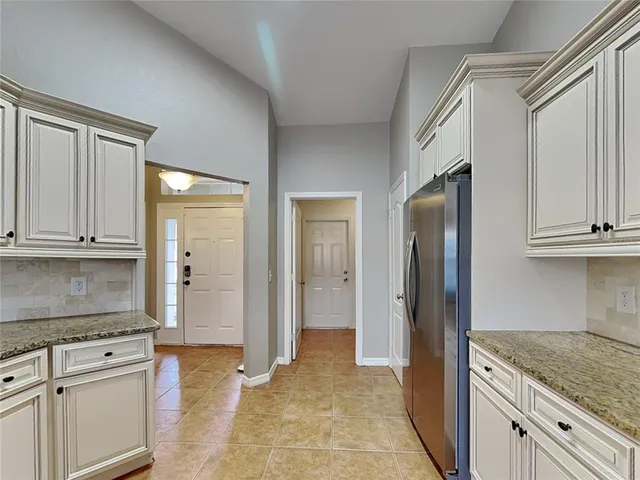 a kitchen with stainless steel appliances granite countertop a refrigerator and a stove