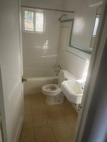 a bathroom with a toilet and shower