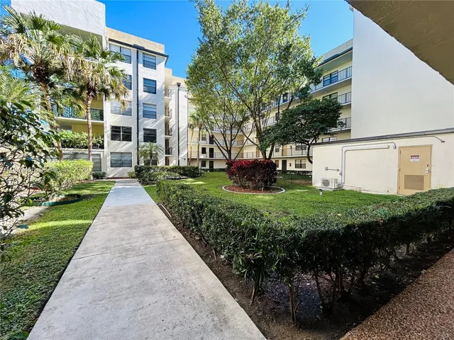 a view of swimming pool with outdoor seating and a tree