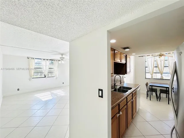 a view of kitchen with furniture and refrigerator