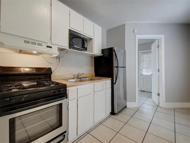 605 Elmwood Place, Unit B Austin, TX 78705 - Photo 1 of 10 a kitchen with appliances and cabinets