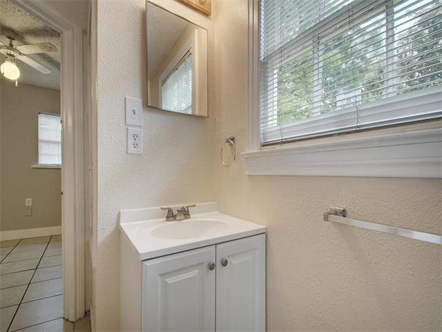 605 Elmwood Place, Unit B Austin, TX 78705 - Photo 8 of 10 a bathroom with a sink and a mirror