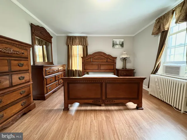 a bedroom with furniture and a window