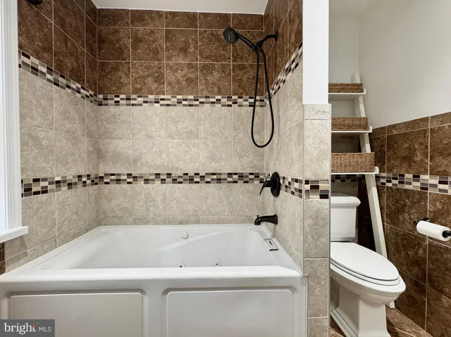 a bathroom with a shower a toilet and a shower