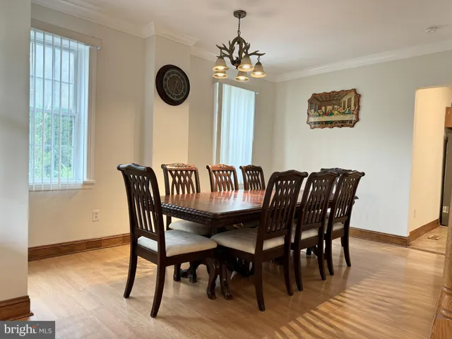 a view of a dining room with furniture wooden floor and a chandelier