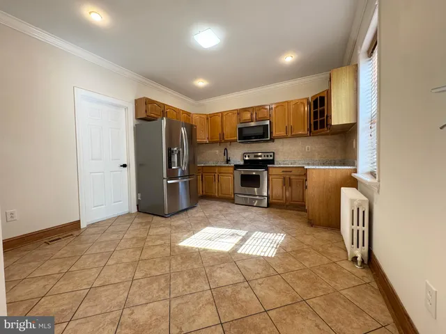 a kitchen with stainless steel appliances granite countertop a refrigerator and a stove top oven