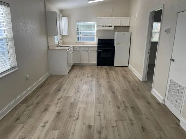 a room with cabinets and wooden floor
