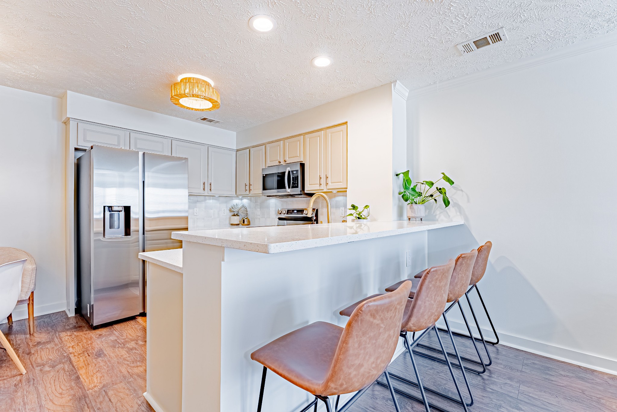 423 Compton Lane Franklin, TN 37069 - Photo 6 of 23 a kitchen with stainless steel appliances a dining table chairs and microwave