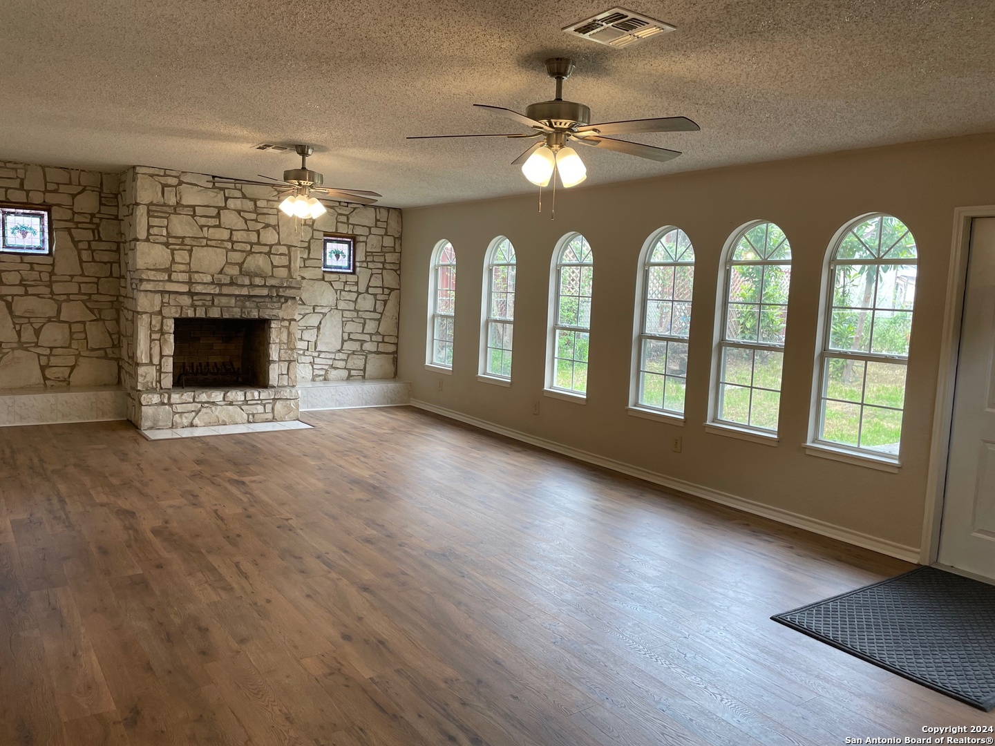 411 Future Drive San Antonio, TX 78213 - Photo 1 of 21 a view of an empty room with chandelier fan and fire place