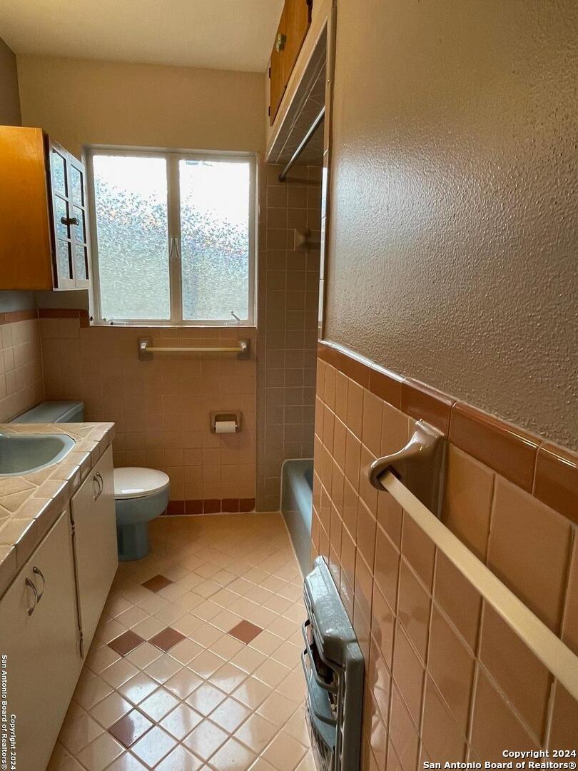 411 Future Drive San Antonio, TX 78213 - Photo 11 of 21 a bathroom with a toilet sink and mirror