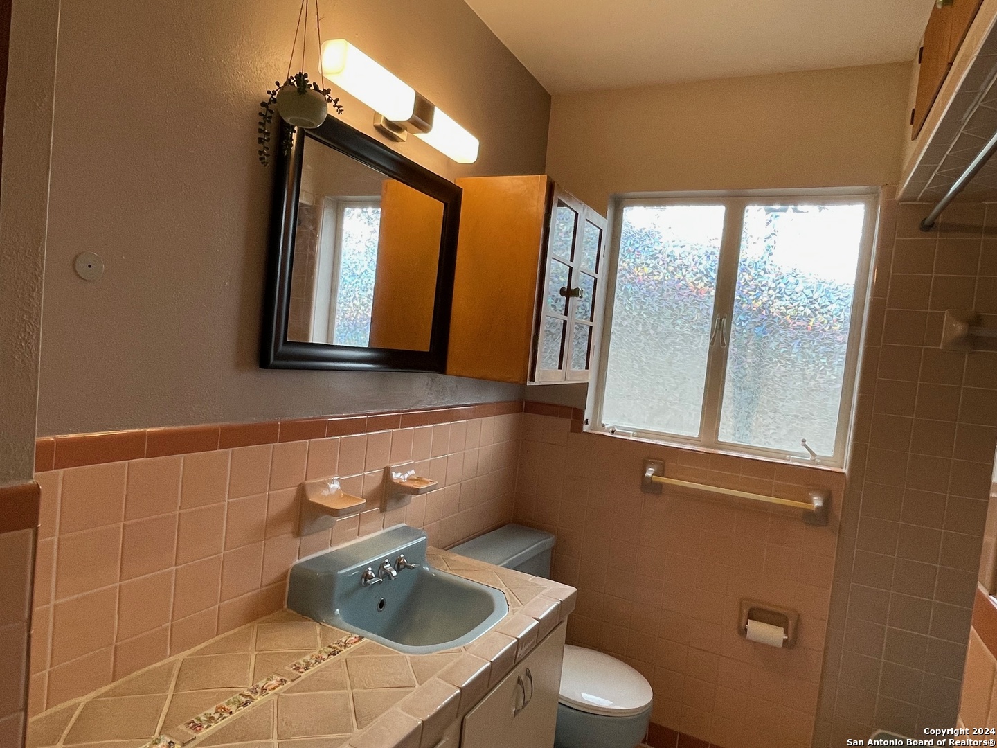 411 Future Drive San Antonio, TX 78213 - Photo 12 of 21 a bathroom with a sink a toilet and mirror