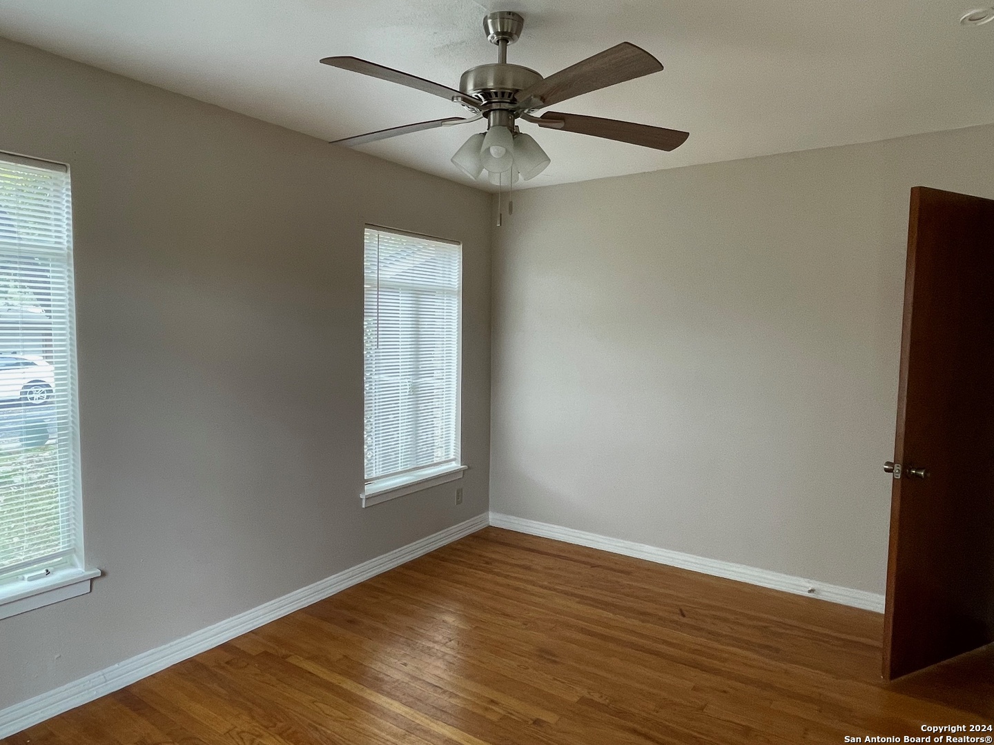 411 Future Drive San Antonio, TX 78213 - Photo 15 of 21 an empty room with wooden floor and windows