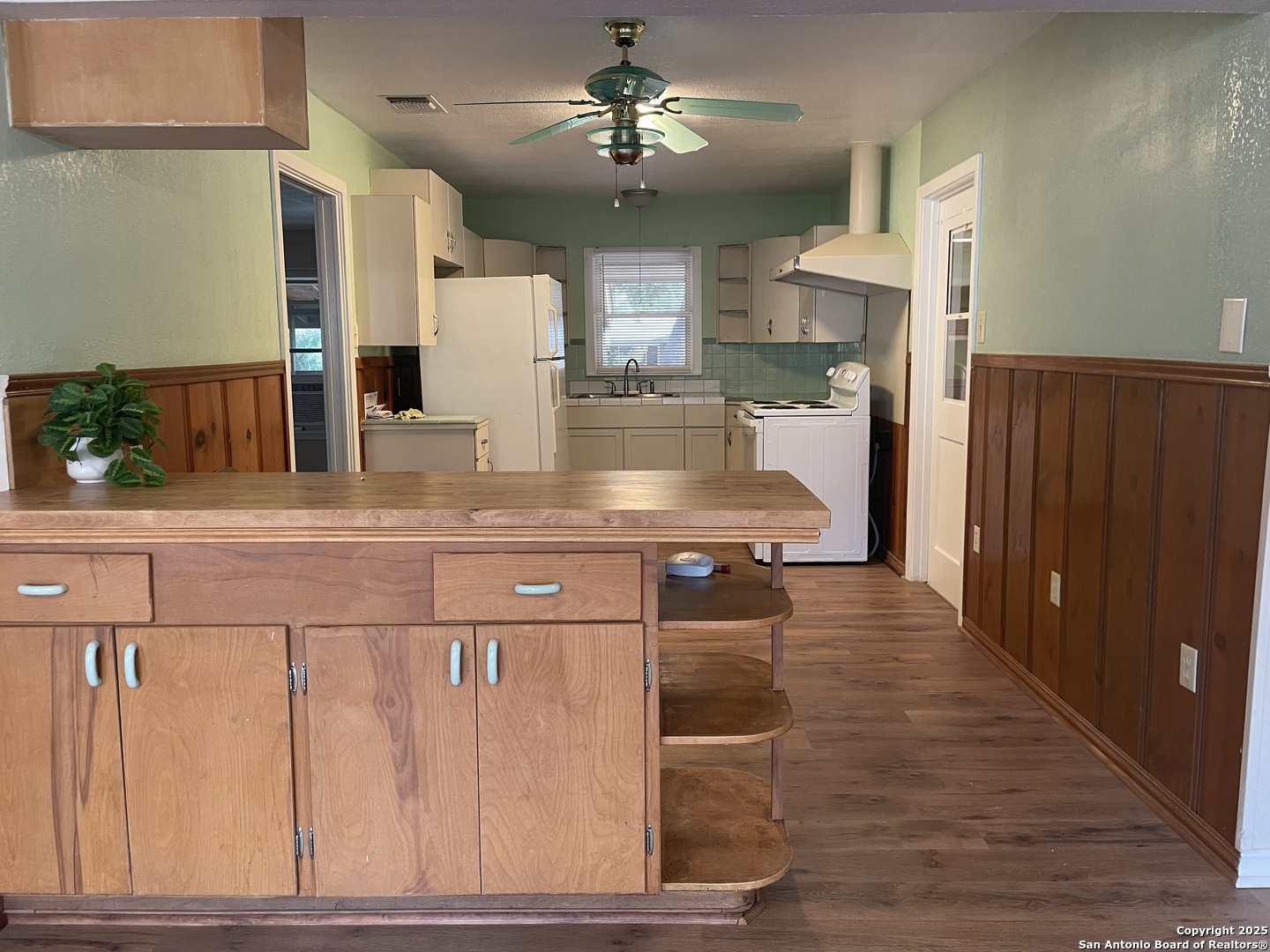 411 Future Drive San Antonio, TX 78213 - Photo 2 of 21 a view of a kitchen with a sink and a refrigerator