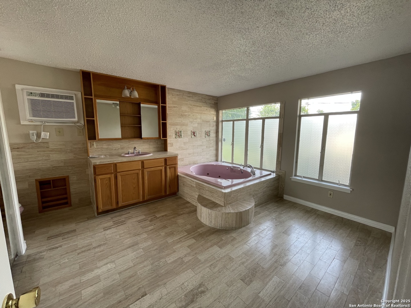411 Future Drive San Antonio, TX 78213 - Photo 5 of 21 a spacious bathroom with a double vanity sink a large mirror and a bathtub