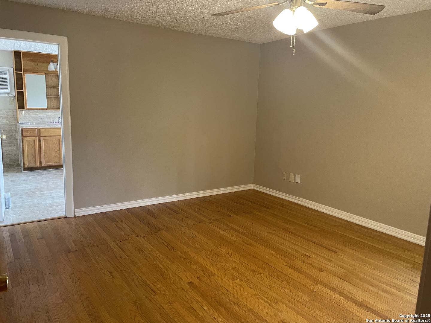 411 Future Drive San Antonio, TX 78213 - Photo 6 of 21 a view of an empty room with wooden floor and a window