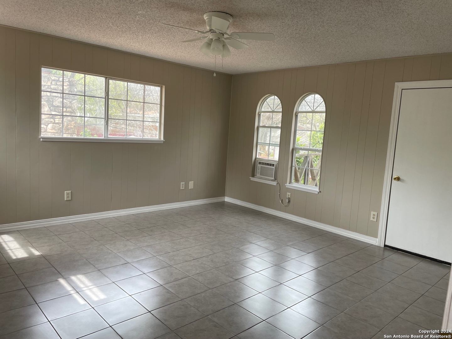 411 Future Drive San Antonio, TX 78213 - Photo 10 of 21 an empty room with windows and chandelier fan
