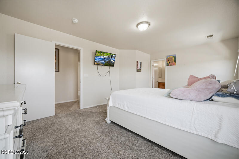 7873 Welsh Drive Reno, NV 89506 - Photo 12 of 34 a bedroom with a bed and painting on the wall