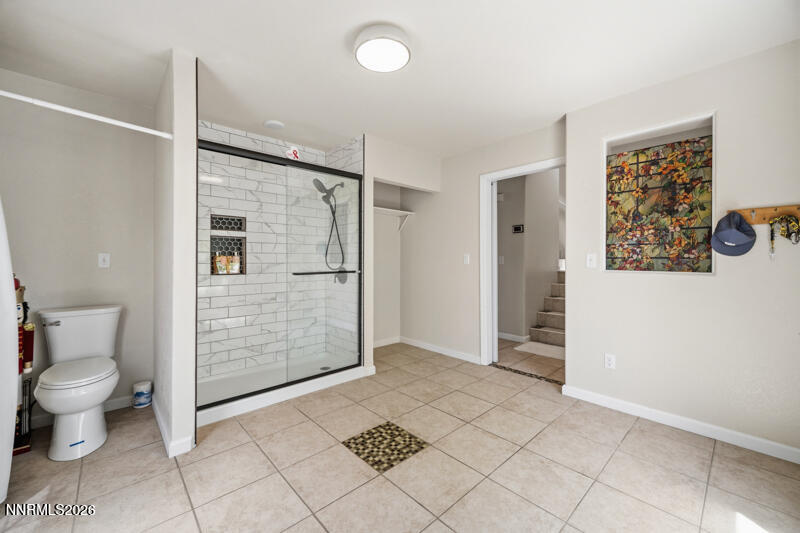 7873 Welsh Drive Reno, NV 89506 - Photo 17 of 34 a bathroom with a glass shower door